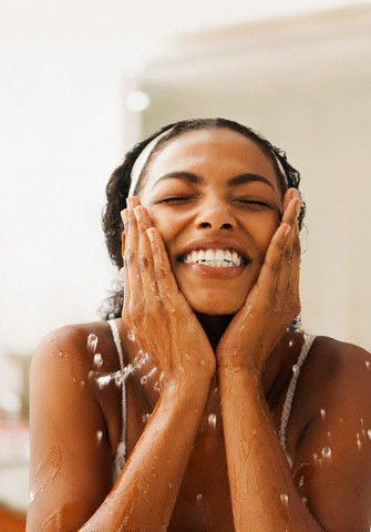 African American woman washing face
